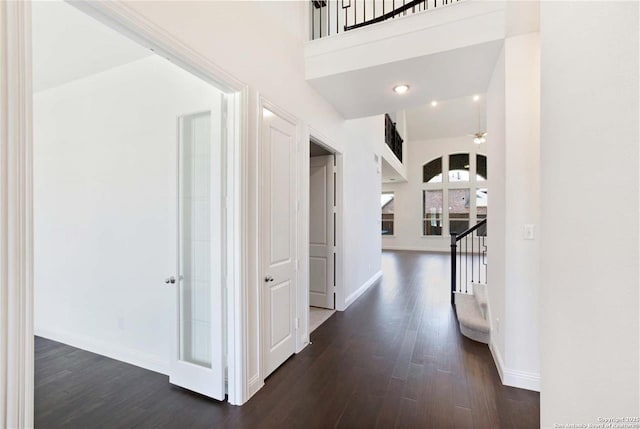 228 Dulce, Boerne, TX 78006 - hall with dark wood-type flooring, baseboards, stairway, and a high ceiling