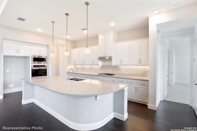 kitchen with stainless steel appliances, dark hardwood / wood-style flooring, white cabinets, sink, and pendant lighting