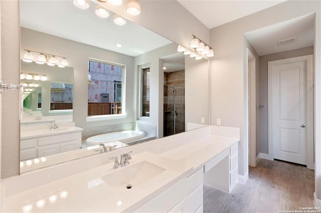 228 Dulce, Boerne, TX 78006 - bathroom featuring a bath, a stall shower, two vanities, and baseboards