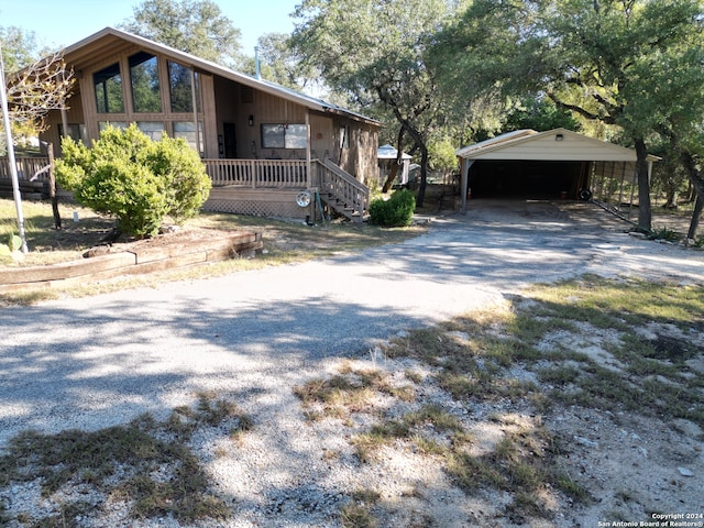 view of front of home with a carport and covered porch