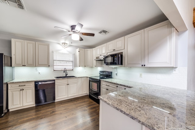 kitchen with black appliances, light stone counters, dark hardwood / wood-style floors, sink, and ceiling fan