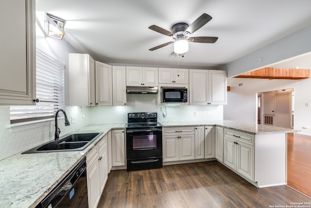 kitchen featuring decorative backsplash, dark hardwood / wood-style flooring, black appliances, and sink