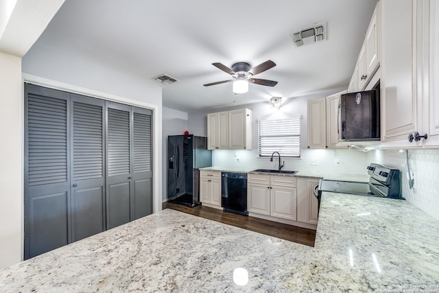 kitchen with sink, black appliances, light stone countertops, ceiling fan, and backsplash