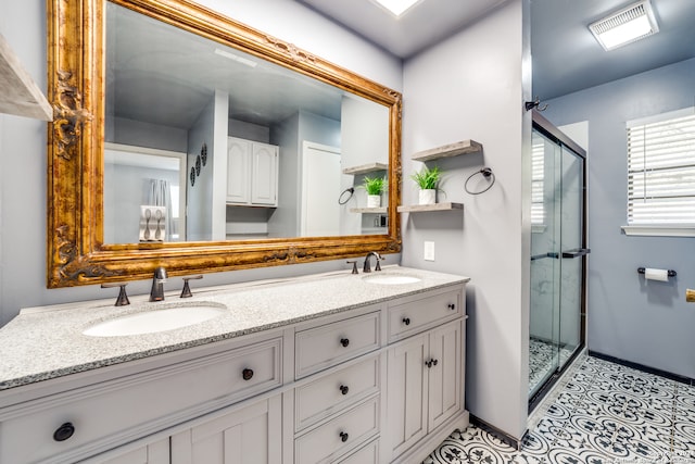 bathroom with vanity and a shower with shower door