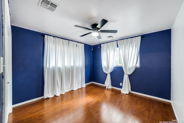 empty room featuring hardwood / wood-style flooring and ceiling fan