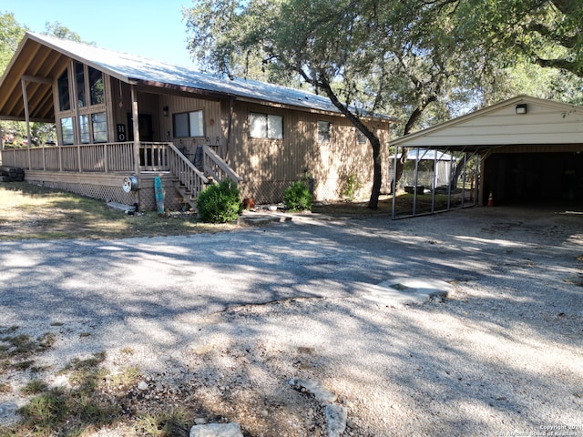 view of property exterior with a porch and a carport