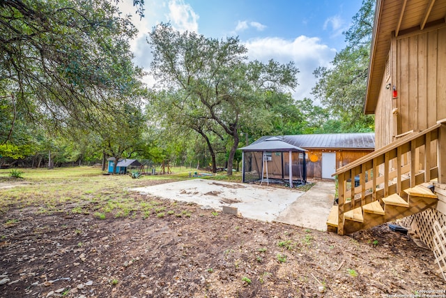 view of yard featuring an outbuilding and a patio area