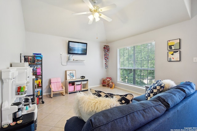 living room with ceiling fan, light tile patterned floors, and lofted ceiling