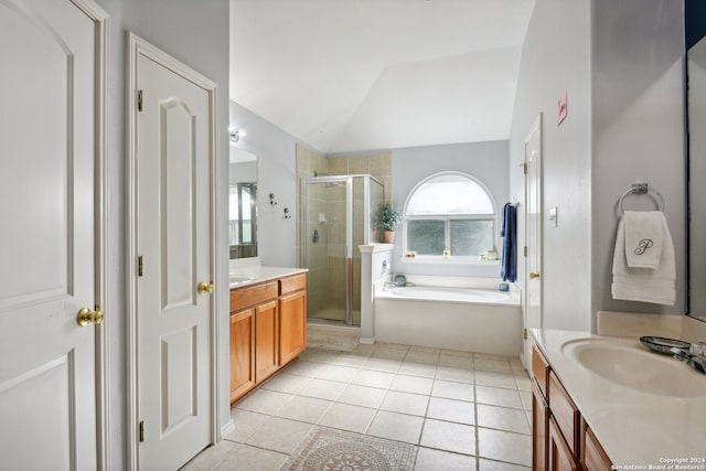 bathroom featuring plus walk in shower, vanity, a healthy amount of sunlight, and vaulted ceiling