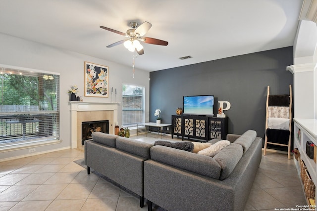 tiled living room featuring ceiling fan and a healthy amount of sunlight