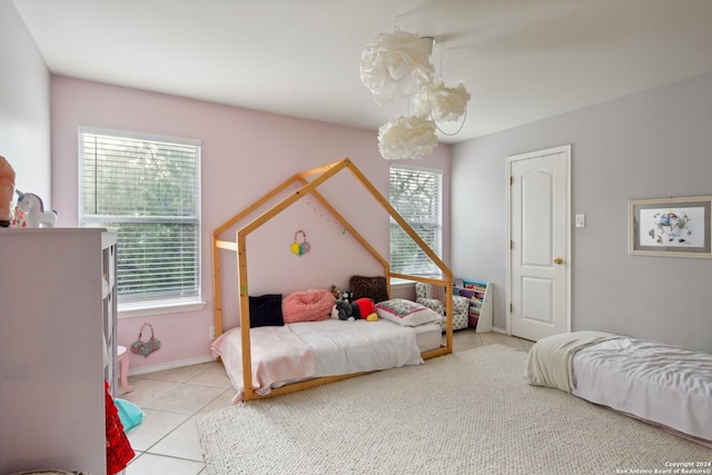 bedroom featuring multiple windows and light tile patterned floors