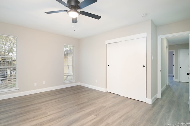 unfurnished bedroom with a closet, ceiling fan, and light hardwood / wood-style floors