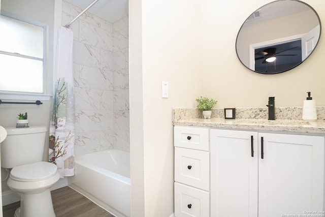 full bathroom featuring hardwood / wood-style flooring, vanity, toilet, and shower / bathtub combination with curtain