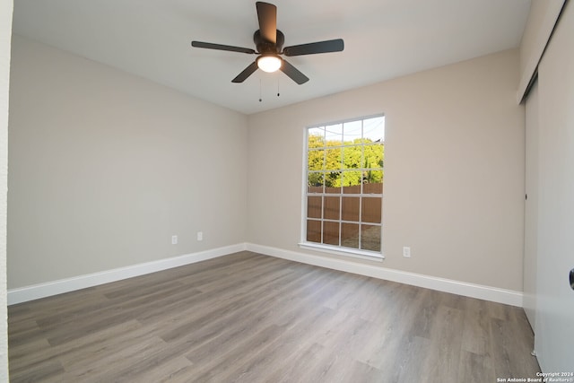 spare room featuring hardwood / wood-style floors and ceiling fan