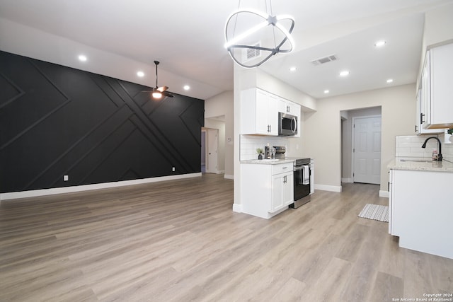 kitchen featuring backsplash, appliances with stainless steel finishes, sink, and white cabinets