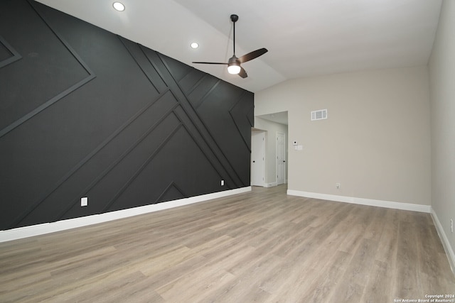 unfurnished living room with vaulted ceiling, ceiling fan, and light hardwood / wood-style flooring