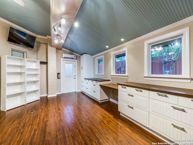 bathroom with wood-type flooring, a wall mounted AC, vaulted ceiling, and ornamental molding