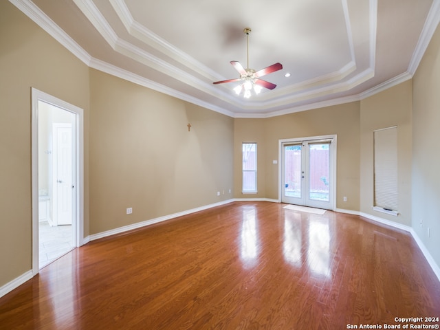 spare room with french doors, hardwood / wood-style flooring, crown molding, and a tray ceiling