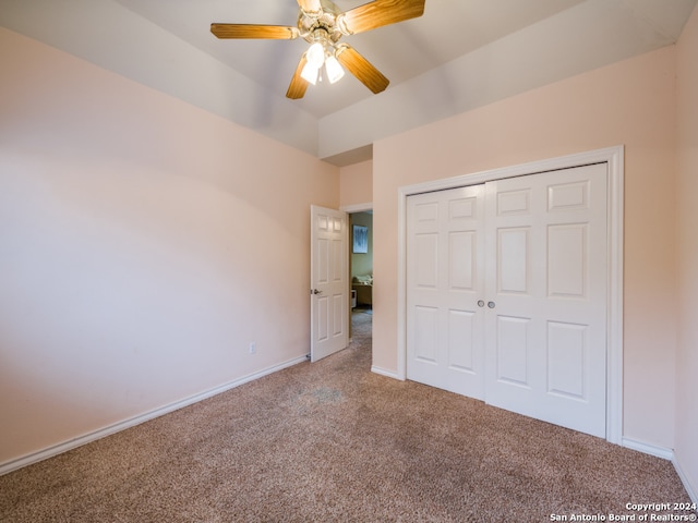 unfurnished bedroom featuring carpet floors, ceiling fan, and a closet