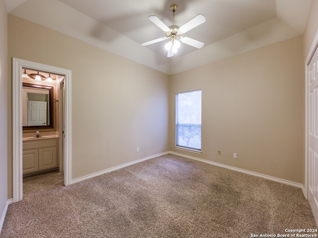 unfurnished bedroom with carpet, sink, ceiling fan, and ensuite bathroom