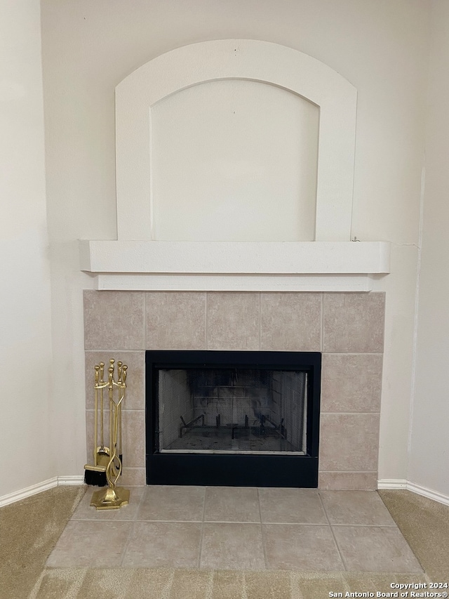 room details with a tile fireplace and tile patterned floors