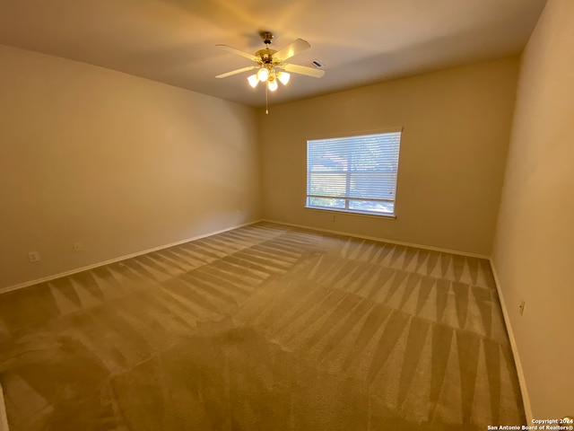 carpeted empty room with ceiling fan