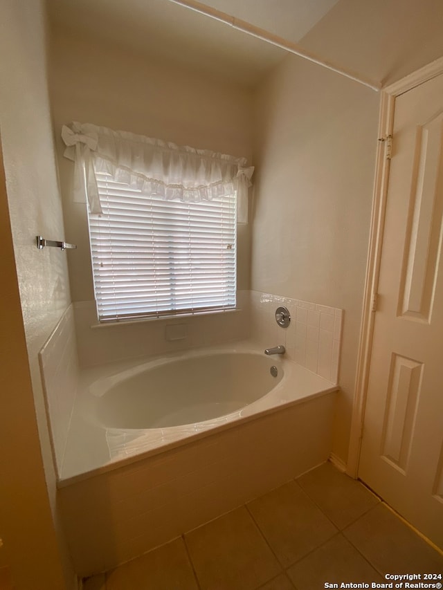 bathroom with a tub and tile patterned floors