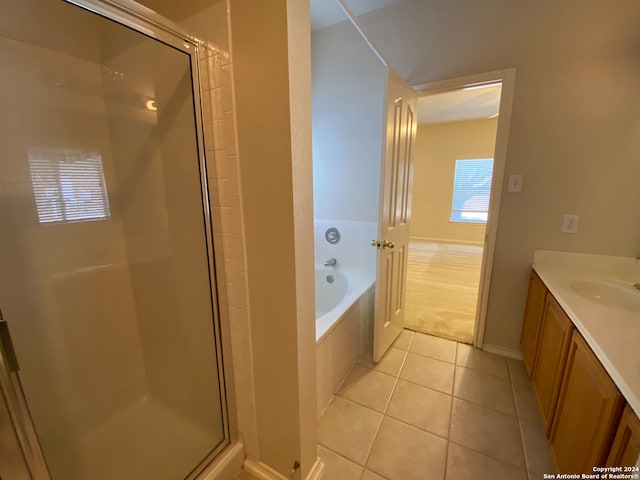 bathroom featuring vanity, tile patterned floors, and shower with separate bathtub