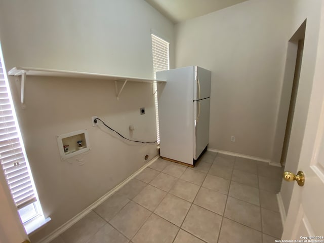 laundry room with hookup for an electric dryer, gas dryer hookup, hookup for a washing machine, and light tile patterned floors