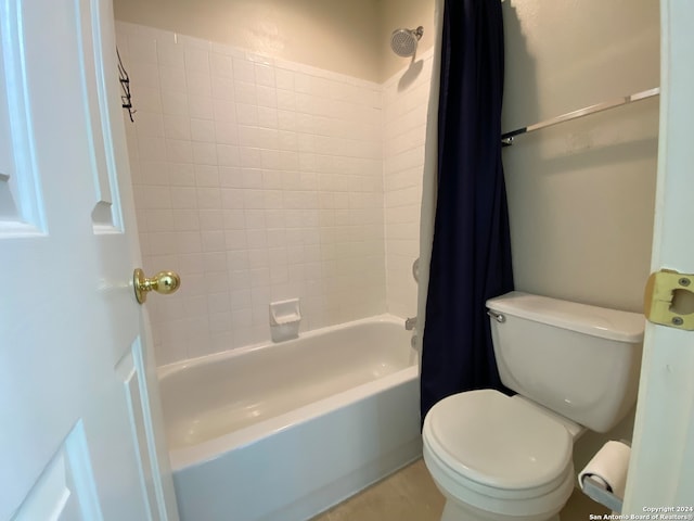 bathroom featuring toilet and shower / bathtub combination with curtain