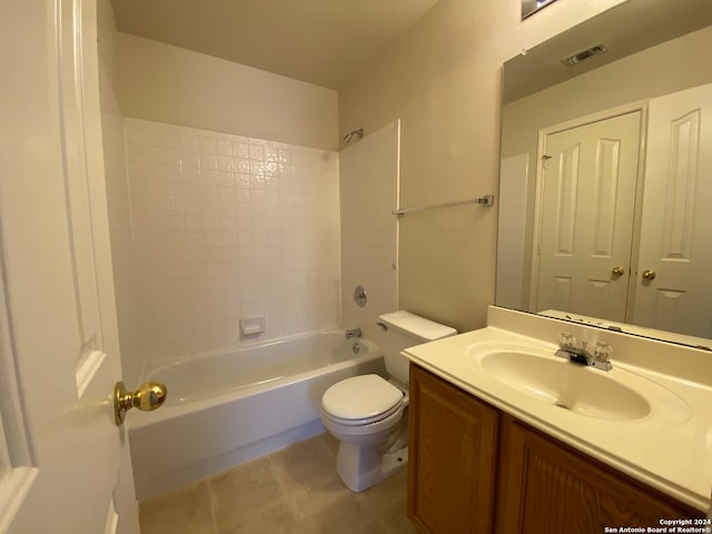 full bathroom with toilet, tiled shower / bath combo, vanity, and tile patterned floors