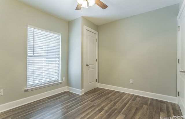 empty room featuring dark hardwood / wood-style floors and ceiling fan