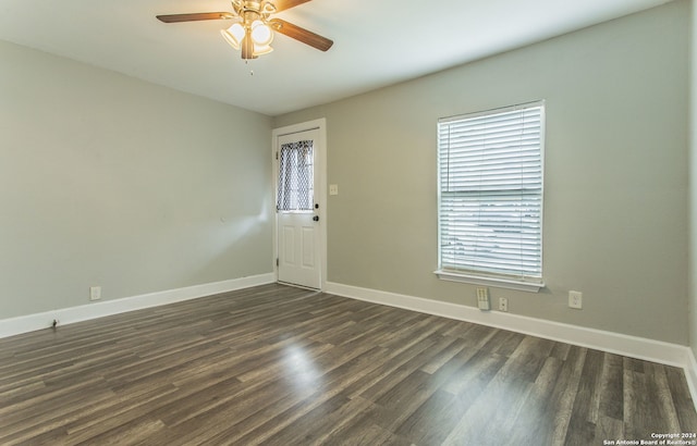 unfurnished room featuring dark hardwood / wood-style flooring and ceiling fan