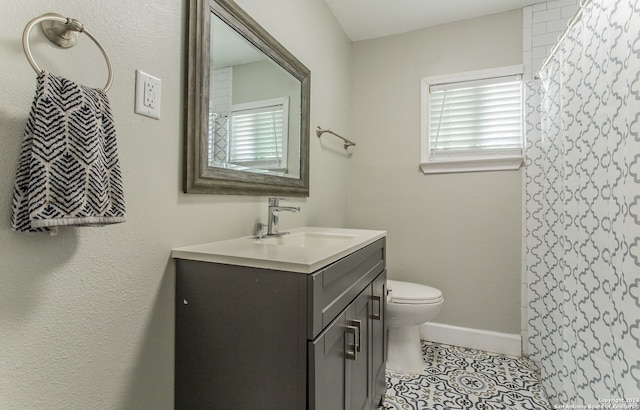 bathroom featuring a shower with curtain, tile patterned flooring, vanity, and toilet