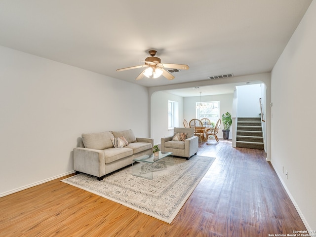 living room featuring hardwood / wood-style flooring and ceiling fan