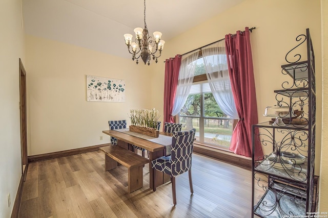 dining room featuring hardwood / wood-style flooring and a chandelier