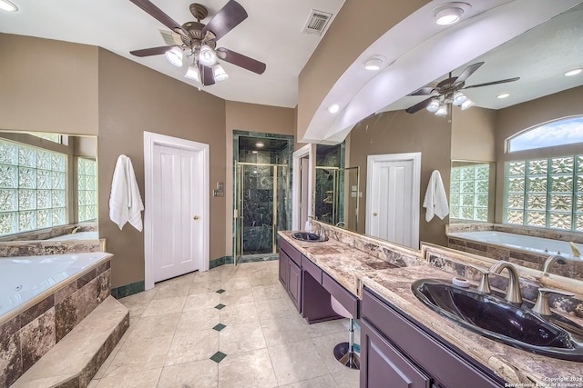 bathroom featuring ceiling fan, vanity, plus walk in shower, and tile patterned floors