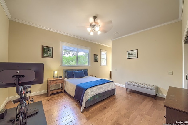 bedroom featuring hardwood / wood-style flooring, ornamental molding, and ceiling fan