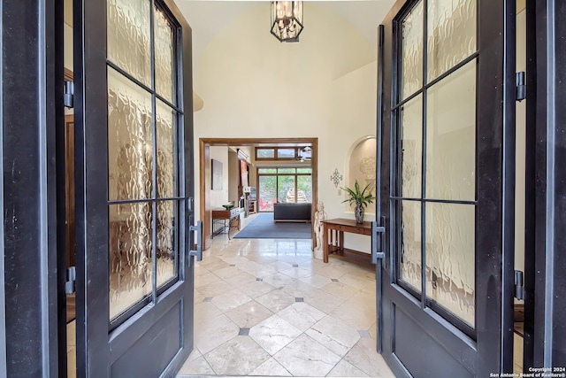 tiled entryway featuring a high ceiling and french doors