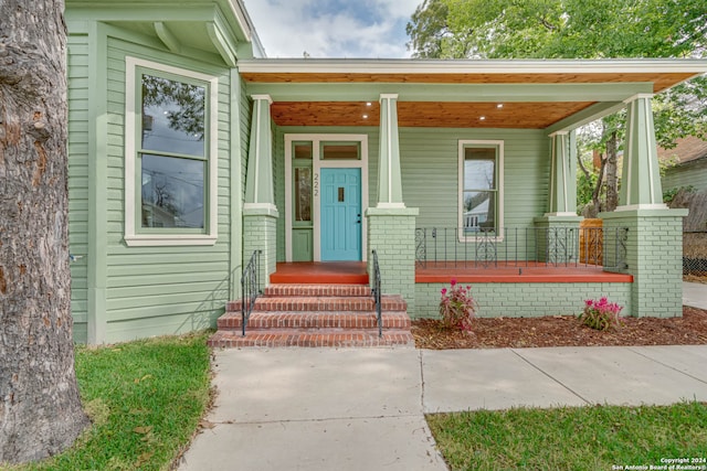 view of exterior entry with covered porch