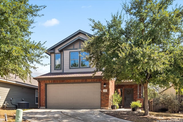 view of front of house with a garage and central AC