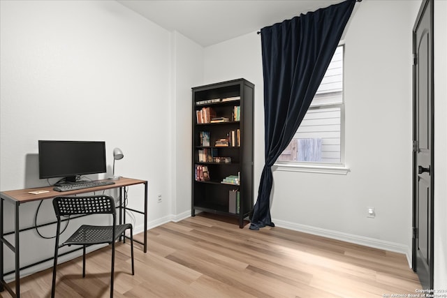 office with light hardwood / wood-style flooring