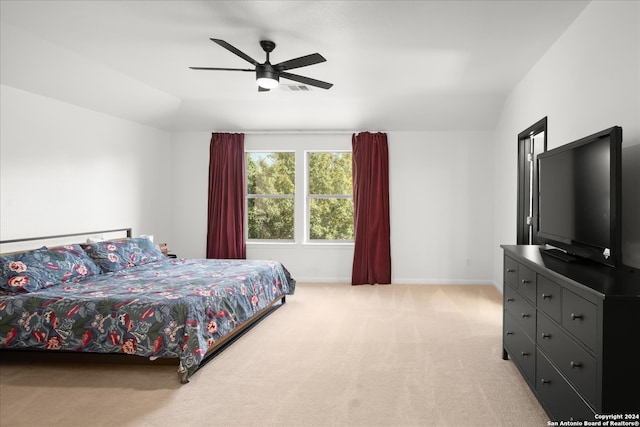 carpeted bedroom with lofted ceiling and ceiling fan