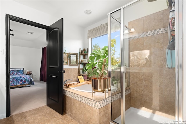 bathroom featuring tile patterned flooring and independent shower and bath