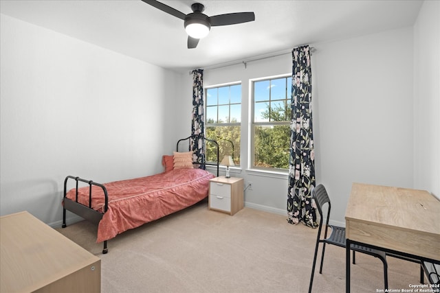 bedroom featuring light colored carpet and ceiling fan