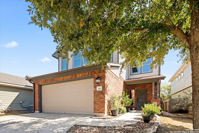 view of front of house featuring a garage and central AC