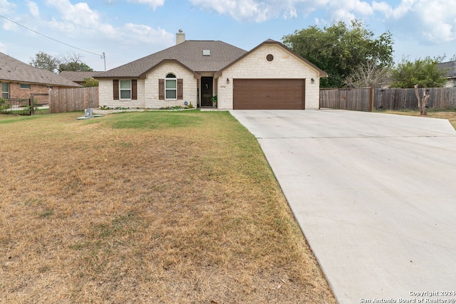 view of front facade featuring a front lawn and a garage