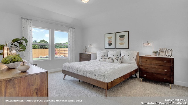 bedroom featuring light carpet and vaulted ceiling