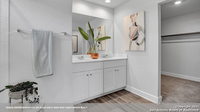 bathroom with vanity and hardwood / wood-style flooring