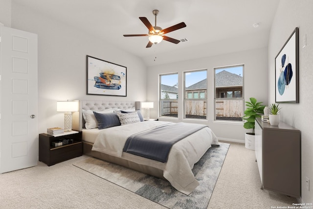 bedroom with ceiling fan, visible vents, vaulted ceiling, and light colored carpet